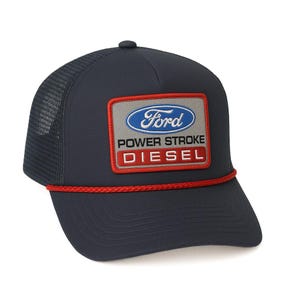 May include: A navy blue trucker hat with a red rope trim and a patch that says "Ford Power Stroke Diesel" in white and red lettering on a gray background.