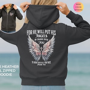 May include: A dark heather gray full-zip hoodie featuring a back graphic of angel wings with a cross and the text: For He will put His angels in charge over you to guard you in all your ways Psalm 91:11. A small matching wing logo is on the front.