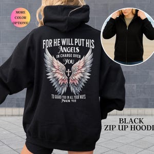 May include: Black zip-up hoodie with a hood and a graphic on the back. The graphic features angel wings, a cross, and the text "FOR HE WILL PUT HIS ANGELS IN CHARGE OVER YOU" and "TO GUARD YOU IN ALL YOUR WAYS PSALM 91:11".