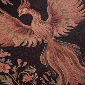 May include: A tapestry featuring a pink phoenix with intricate details, set against a dark background with floral patterns.