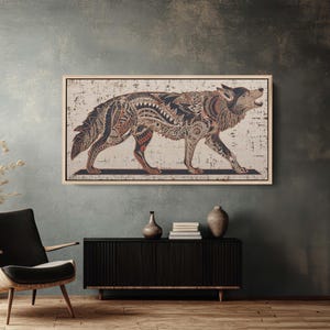 May include: A framed artwork featuring a detailed illustration of a wolf. The wolf is depicted in profile, walking with its mouth open. The artwork uses a palette of brown, black, and red, with intricate patterns filling the wolf's body. The background is a distressed white.