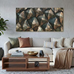 May include: A rectangular wall art piece featuring a geometric, three-dimensional pattern with metallic bronze and dark green tones. The artwork is displayed above a light-colored sectional sofa with various throw pillows and a wooden coffee table.