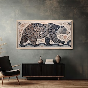 May include: A framed artwork featuring a detailed illustration of a bear walking to the right. The bear is adorned with floral and botanical patterns in shades of brown, blue, and cream. The artwork is set against a neutral background.