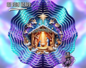 May include: A purple and blue metal wind spinner with a Christmas nativity scene design. The scene features a stable with a star above it, a manger with baby Jesus, Mary, Joseph, and animals. The text "FREE DESIGN INCLUDED!" is at the top of the image.