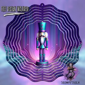 May include: A layered design in shades of purple and blue, featuring a nutcracker at its centre. The nutcracker is wearing a blue hat and a blue and gold uniform. The text "FREE DESIGN INCLUDED!" is at the top of the image.