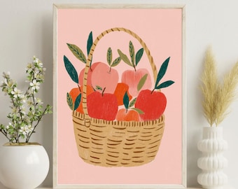 Pode incluir: Uma impressão emoldurada com uma cesta cheia de maçãs. As maçãs são vermelhas, laranja e rosa, com folhas verdes. A cesta é tecida e o fundo é rosa claro. A impressão é exibida em uma prateleira branca.