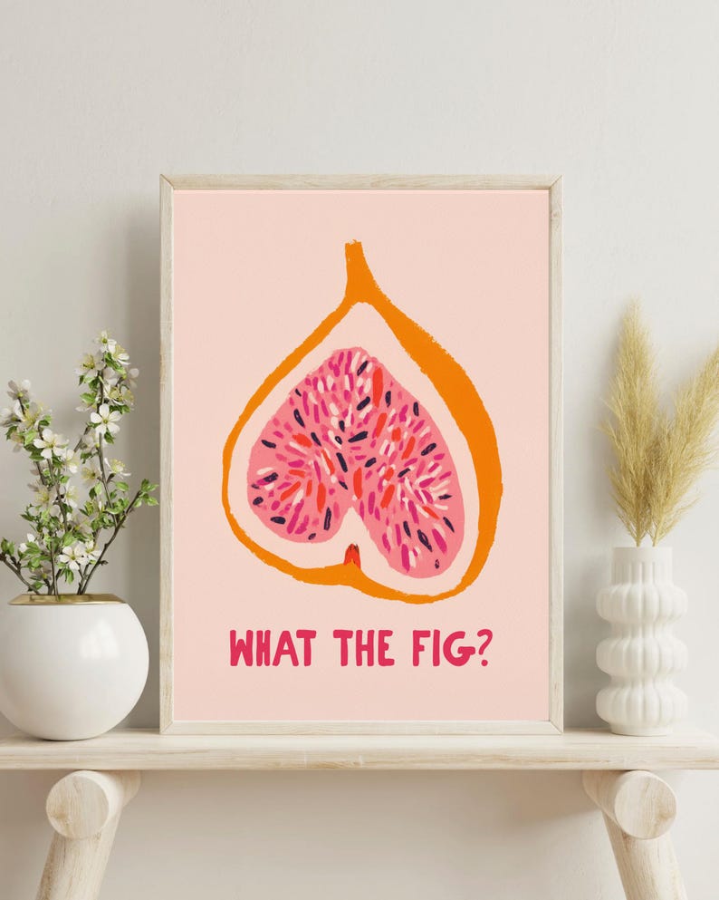 Pu&ograve; includere: Stampa artistica incorniciata con un fico tagliato a met&agrave;, arancione e rosa su sfondo rosa chiaro. Il testo "WHAT THE FIG?" &egrave; stampato in rosso sotto. La stampa &egrave; esposta su una mensola bianca. Design moderno e minimalista.
