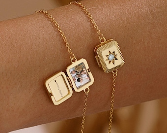 May include: Two gold-toned chain bracelets featuring rectangular locket charms. One locket is closed, displaying a starburst design with a central stone. The other locket is open, revealing a small photograph and the text "Family Forever" inside.