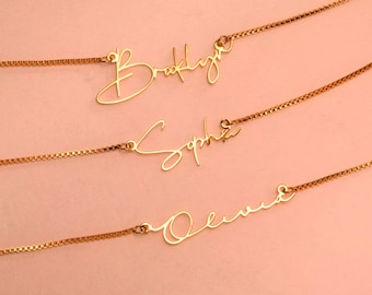 May include: Three gold necklaces with the names Brooklyn, Sophie, and Olivia written in cursive script.