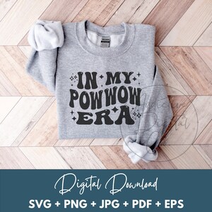 May include: A gray sweatshirt with the text "IN MY POWWOW ERA" in black lettering with stars around the text.