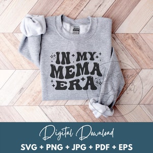 May include: A gray sweatshirt with the text "IN MY MEMA ERA" in black, with sparkling stars around the text.