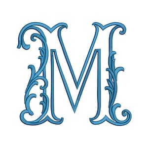 May include: A capital letter M rendered in a blue embroidery stitch pattern. The letter features an ornate, swirling filigree design integrated into the left and right vertical strokes, creating a decorative, textured appearance on a white background.