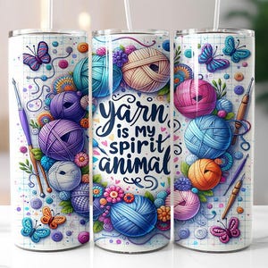 May include: A white tumbler with a colourful design featuring yarn balls, butterflies, and the text "yarn is my spirit animal".
