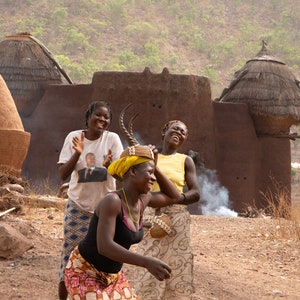 Togo, Village dance, Three African women laughing and dancing at the traditional village street, Classic Matte Paper Poster