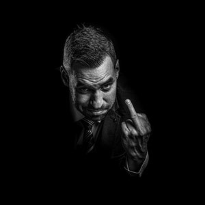 Man giving finger, low key portrait, black background man, low key mans head, giving middle finger, dark mans portrait,