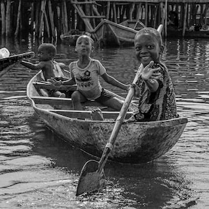 Benin, Lake Nokoue vater village, Happy Benin children are having fun in a boat, Plack and white photo  - Museum-Quality Matte Paper Poster