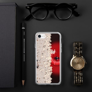 May include: A clear phone case with a red and white design. The design features a white silhouette of a person sitting on a red crescent moon with white flowers and a white pattern in the background.