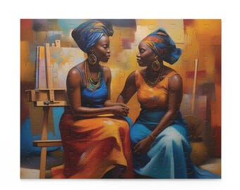 May include: Two women wearing colorful head wraps and dresses sit in front of an easel. The woman on the left is wearing a blue and orange dress, while the woman on the right is wearing a yellow and blue dress. The background is a colorful abstract painting.
