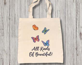 May include: A white tote bag with four colorful butterflies and the text "All Kinds Of Beautiful!" printed on it.