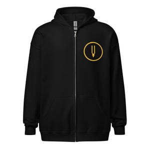 May include: Black zippered hoodie with a gold circle logo featuring a tuning fork symbol.