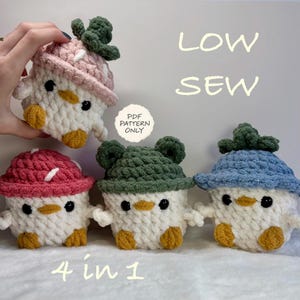 May include: Four crocheted plush figures with white bodies, yellow beaks, and yellow feet. Each figure wears a different coloured hat: pink, dark pink, green, or blue. The green hat has frog-like ears. Text reads: LOW SEW, PDF PATTERN ONLY, 4 in 1.