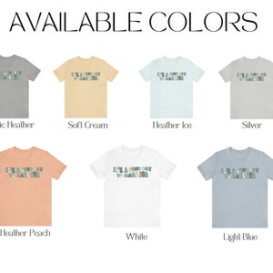 May include: A mockup of a t-shirt with the text "It's a good day to make a good day" in a colourful font. The t-shirt is shown in 10 different colours: Athletic Heather, Soft Cream, Heather Ice, Silver, Heather Peach, White, Light Blue, Black, Navy, and Red.