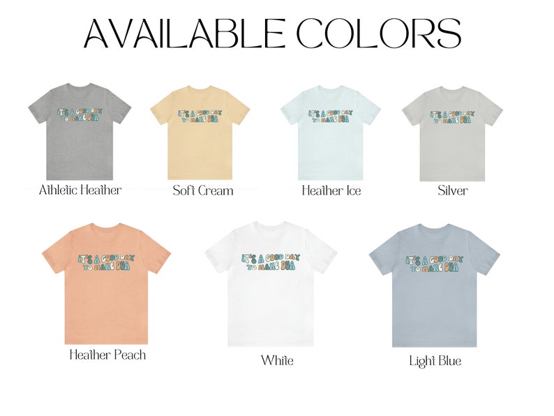 May include: A mockup of a t-shirt with the text "It's a good day to make a good day" in a colourful font. The t-shirt is shown in 10 different colours: Athletic Heather, Soft Cream, Heather Ice, Silver, Heather Peach, White, Light Blue, Black, Navy, and Red.