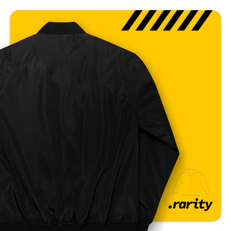 May include: A black bomber jacket with a zipper closure. The jacket has a ribbed collar, cuffs, and waistband. The back of the jacket has the text ".rarity" printed on it.