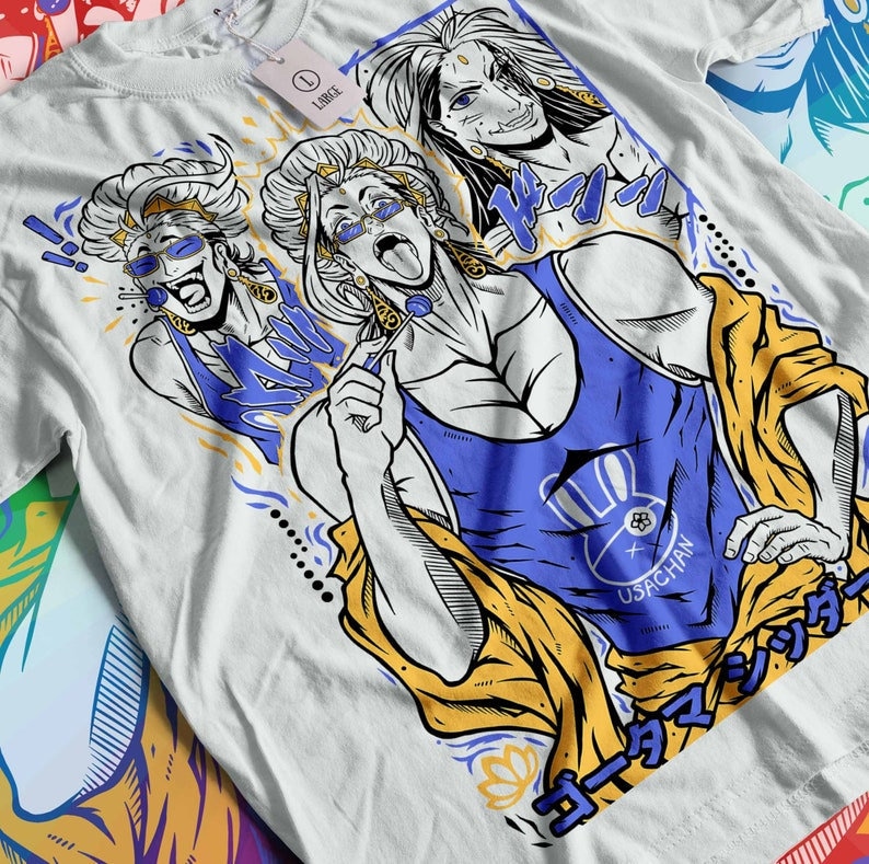 May include: White t-shirt with a graphic print of three cartoon characters. The characters are wearing colorful clothing and have exaggerated features. The text "USACHAN" is printed on the shirt. The shirt is a large size.