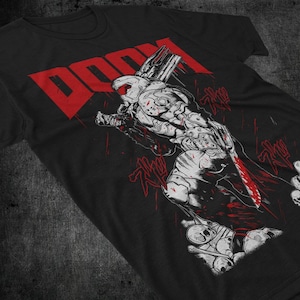 May include: Black t-shirt with a white graphic of a demon holding a weapon and the word "DOOM" in red letters.