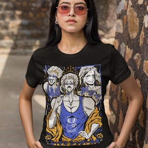 May include: Black t-shirt with a graphic print of three anime characters. The characters are wearing colorful clothing and have exaggerated features. The text "UDACHAN" is printed on the shirt. The text "ローマン シックルール" is printed on the bottom of the shirt.