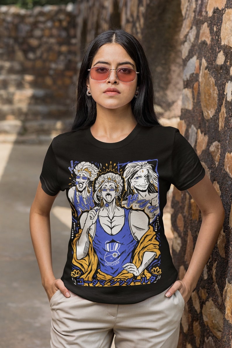 May include: Black t-shirt with a graphic print of three anime characters. The characters are wearing colorful clothing and have exaggerated features. The text "UDACHAN" is printed on the shirt. The text "ローマン シックルール" is printed on the bottom of the shirt.