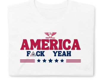 May include: White t-shirt with red text that says "AMERICA FACK YEAH" with a red eagle above the text and five stars and three red stripes below the text.