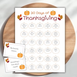 May include: A Thanksgiving-themed printable with the text "30 Days of Thanksgiving" and prompts for each day. Includes two small cards with the phrases "My favourite season" and "Something I love about myself."