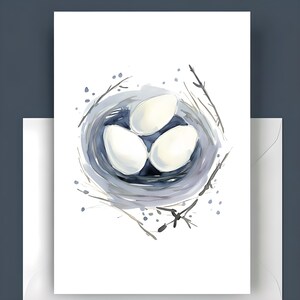 May include: Watercolor illustration of a bird's nest with three white eggs. The nest is a soft blue-gray, with delicate branches and splatters of paint around the edges. The image is on a white background.