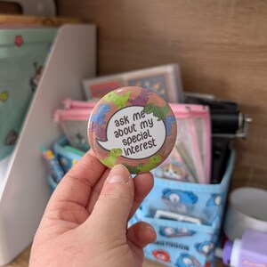 Dinosaur Special Interest Badge: Neurodivergent Pride Pin (58mm)