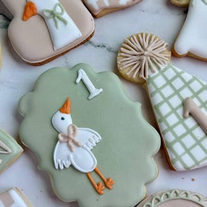 Custom first birthday sugar cookies with hand-decorated geese, party hats, balloons, “Parkery Ryan is One,” "custom name" “Silly Goose,” and number 1 designs in soft sage green, beige, white, and peach tones — perfect for a goose-themed birthday party or personalized baby celebration.