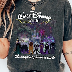 May include: Dark gray t-shirt featuring a graphic of Disney villains and the text "Walt Disney World" and "The happiest place on earth". The graphic includes a castle and fireworks.