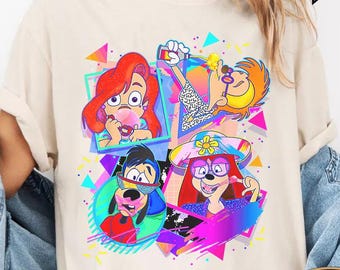 May include: A white t-shirt with a retro-style graphic print featuring four cartoon characters. The characters are a dog, a woman with a hat, a woman with long red hair, and a woman with a ponytail. The graphic is surrounded by colorful geometric shapes. The shirt is available in ivory.