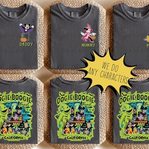 May include: Dark grey t-shirts with Halloween designs. Some feature cartoon characters with text including "Daddy," "Mommy," and "Name." Other shirts display a graphic for the "Oogie Boogie Bash" event in California, with the year 2025.