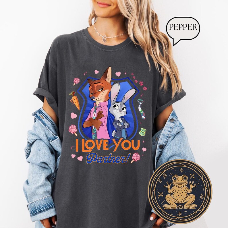 May include: Dark gray t-shirt featuring cartoon characters Nick Wilde and Judy Hopps from Zootopia, with the text "I Love You Partner!" and decorative elements. The shirt is a comfortable, casual style.