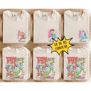 May include: Six cream-colored t-shirts with various Toy Story character designs. Some shirts feature individual characters like Mr. Potato Head and Jessie, while others display a group graphic with the text "TOY STORY" and "Since 1995". A yellow starburst graphic reads "WE DO ALL CHARACTER".