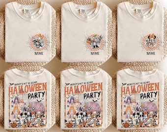 May include: A collection of cream-colored t-shirts featuring Disney character skeleton graphics. The top row displays individual characters in spiderwebs with the text NAME. The bottom row shows a group scene with the text MICKEY'S NOT SO SCARY HALLOWEEN PARTY.