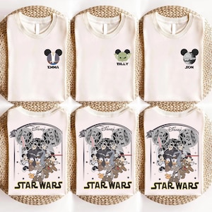 May include: Six off-white t-shirts with Disney and Star Wars designs. Three shirts have Mickey Mouse-themed graphics with names, and three feature a Star Wars graphic with characters and the text "STAR WARS".