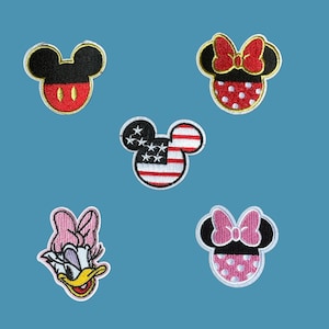 May include: Five embroidered iron-on patches featuring different Disney characters. The patches include Mickey Mouse, Minnie Mouse, Donald Duck, and two versions of Minnie Mouse with different colored bows.