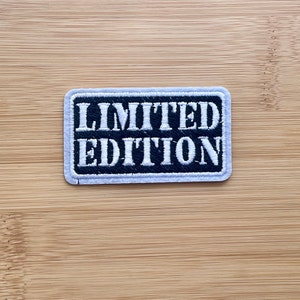 May include: A black and white embroidered patch with the text "LIMITED EDITION" in white lettering.