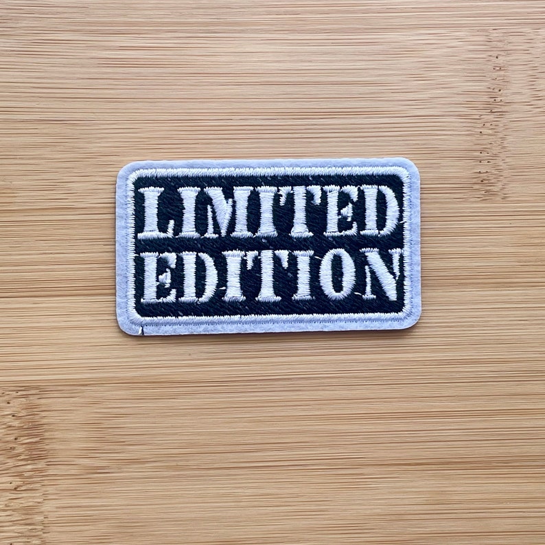 May include: A black and white embroidered patch with the text "LIMITED EDITION" in white lettering.
