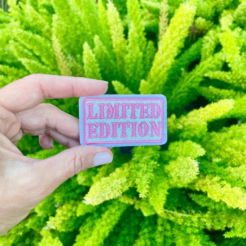 May include: A light blue fabric patch with pink embroidered text that reads "LIMITED EDITION".