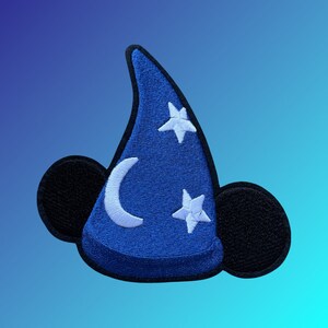 May include: Blue felt patch with a Mickey Mouse ear shape. The center of the patch is a blue and white wizard hat with a crescent moon and two white stars.