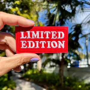 May include: A red fabric patch with white embroidered text that reads "LIMITED EDITION".